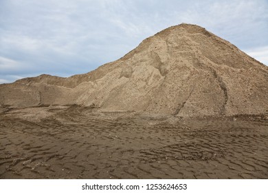 Gravel sand mound against a blue sky