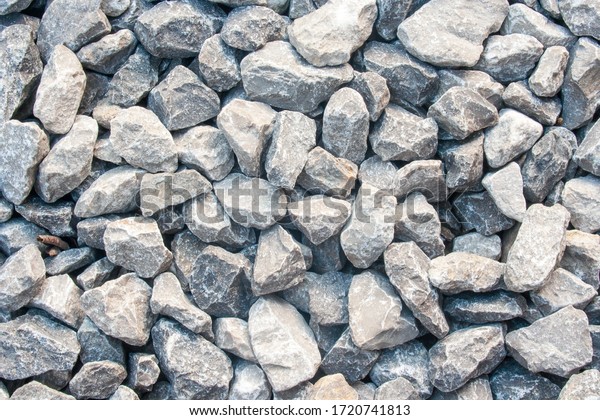 Gravel texture. Pebble\
stone background. Light grey closeup small rocks. Top view of\
ground gravel road.