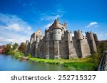 Gravensteen castle in Ghent, Flemish region of Belgium during daytime in summer view with river from the bridge