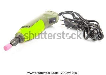 graver and drilling electric tool on a white background. dremel for processing materials and repairing parts