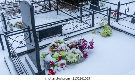 Graves with artificial flowers in the cemetery in winter. Orthodox traditional cemetery in snowy winter. Space for text. - Powered by Shutterstock