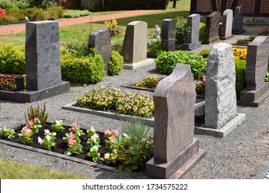 Graves in a well-kept village cemetery - Shutterstock ID 1734575222
