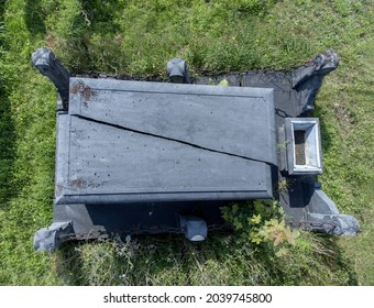 Gravestone At A Cemetery With A Big Crack In The Middle And No Writing On Blank Grave Stone