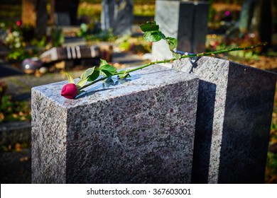 Gravestone With Withered Rose / Tombstone On Graveyard / Sorrow About Loss Of Beloved Ones