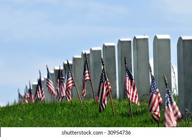 Gravestones decorated with U.S. flags to commemorate Memorial Day at the Arlington National Cemetery in Arlington, Virginia, near Washington DC. Narrow DOF.