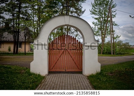graveyard arch shaped gate without fence.