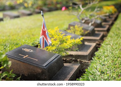 Graveyard With Gravestone With Green Grass And Union Jack Flag. No People 