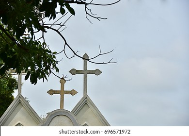 Graveyard With White Cross In The Green Meadow