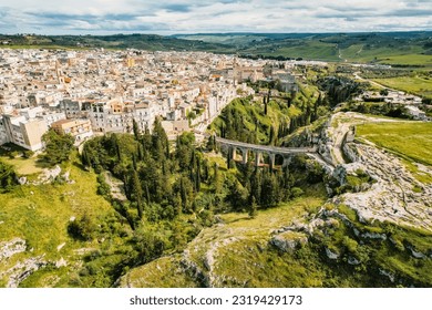 Gravina in Puglia, Apulia Bari, Italy: landscape from the ancient aqueduct bridge of the old rock church and the cave houses carved into the tuff rock