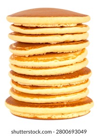 Gravity defying extremely tall stack of fluffy breakfast pancakes isolated on a pure white background.
