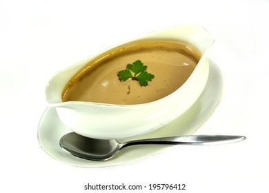 Gravy In A Bowl With Parsley And A Spoon.