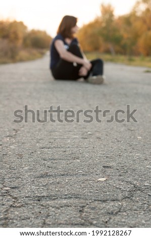 Similar – Stylisch lächelnder Teenager, der auf der Straße sitzt.