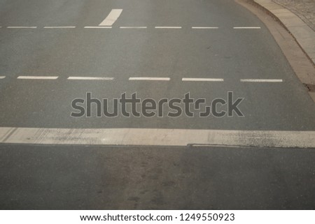 Gray asphalt road with white stripes