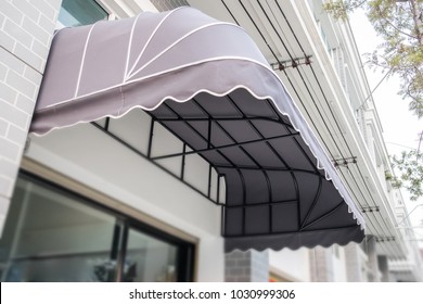 Gray Awning Is Installed Above The Front Door Of The Shop.