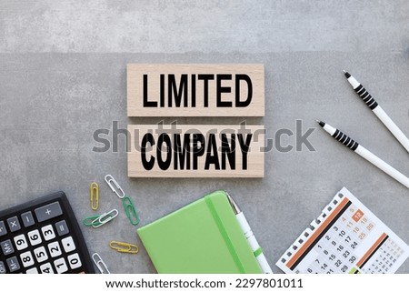 gray background with text Limited company on wooden sides