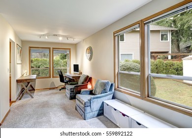 Gray And Beige Home Office Interior With Rustic Tables And Comfortable Gray Velvet Reading Armchairs. Large Windows Overlooking The Backyard. Northwest, USA