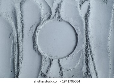Gray bentonite cosmetic clay powder (facial mask, body wrap, eye shadow) texture close up, selective focus. Abstract background with circle place for text. 