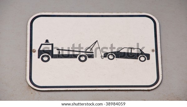 gray and black vehicles
towing sign