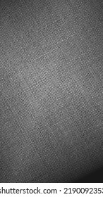 Gray Or Black And White Woven Surface Close Up. Linen Textile Texture. Fabric Handicraft Vertical Background. Textured Braided Grey Backdrop. Len Mobile Phone Wallpaper With Vignetting. Macro