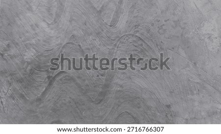 Gray blurred texture with wave-like patterns resembling stone or concrete, subtle tactile appearance.