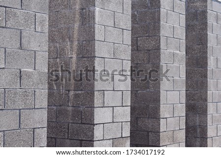 Gray bricks stacked into stone pillars