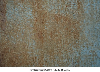 Gray brown rust texture. Old painted metal surface. Close-up. Dark rusty iron background with space for design. Grungy, distressed, weathered.
