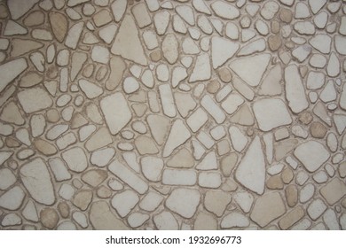 Gray and brown stone tiles of various shapes. Chipped stone wall background. Vertical format. Place for text