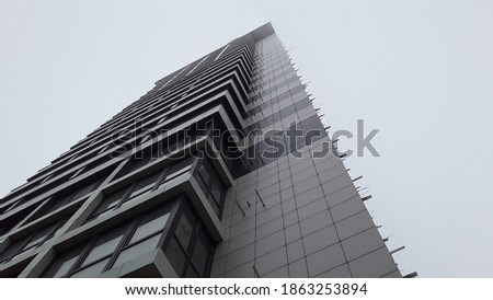 Gray building in cloudy sky