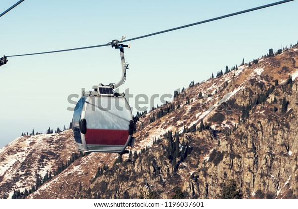 gray cable car over the mountains in Kazakhstan\
Almaty Medeo.