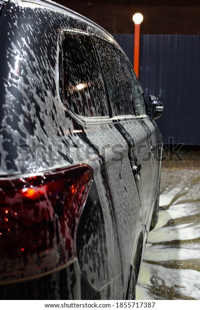 Gray car\
in foam. Car wash. The concept of a pure\
car