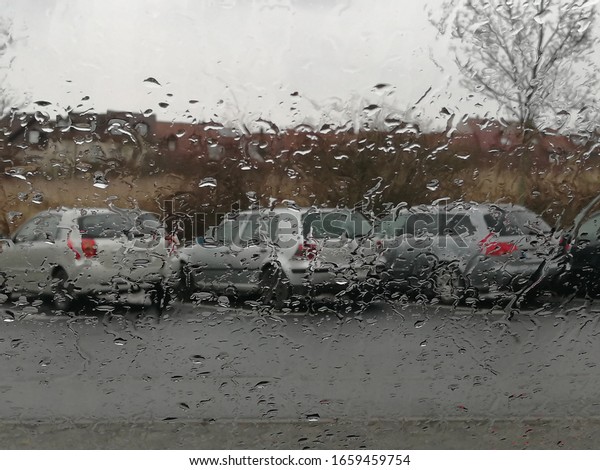 Gray cars in gray rainy\
weather