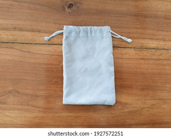 Gray cloth bag placed on the wooden floor - Shutterstock ID 1927572251