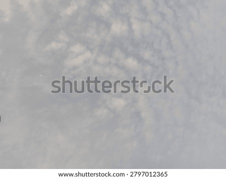 Gray clouds covering the sky before rainfall, with hazy air and low visibility from particulate pollution, creating a gloomy weather atmosphere.