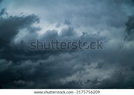 Gray clouds. Evening city in rainy weather. A courtyard in the city. Thunderous clouds. Summer rain