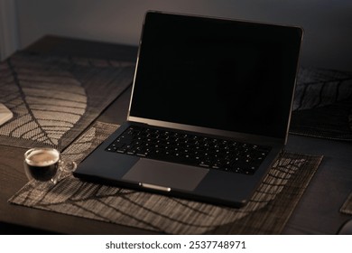 Gray computer with a cup of coffee