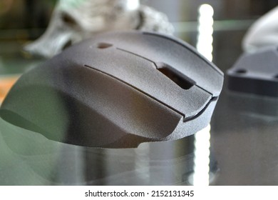 Gray computer mouse printed on 3D printer. Model printed on 3D printer made of plastic close-up. Object of 3D printed model. Prototype of various shapes made by 3d printer. Symbol innovative