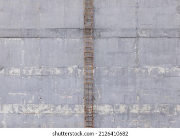 Gray Concrete Wall With Rusty Metal Stairs Front View