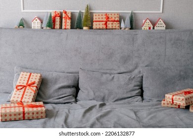 Gray Couch Decorated With Christmas And New Year Gifts And Baubles In Living Room. No People. Home Festive Decor.