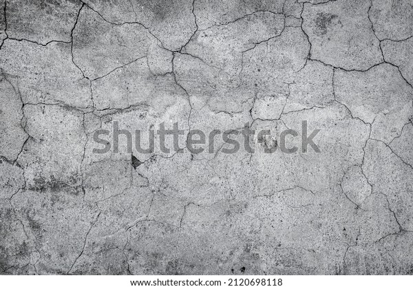Gray cracked\
stucco, concrete and cement wall pattern. Asymmetric and abstract\
broken on textured\
Background.
