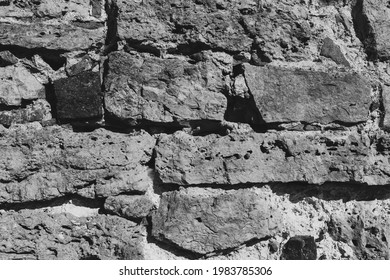 Gray, dark background of stone wall texture close-up.