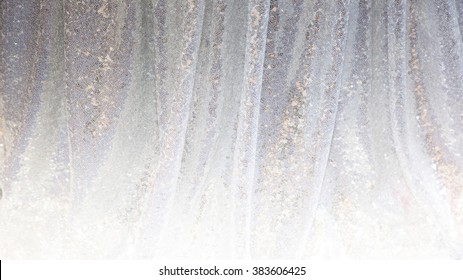 Gray decorative background of draped fabric with sparkles