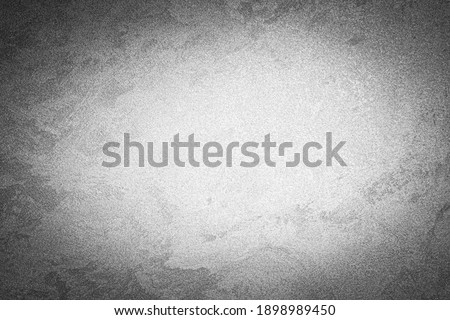 Gray decorative plaster texture with vignette. Abstract grunge background with copy space for design.
