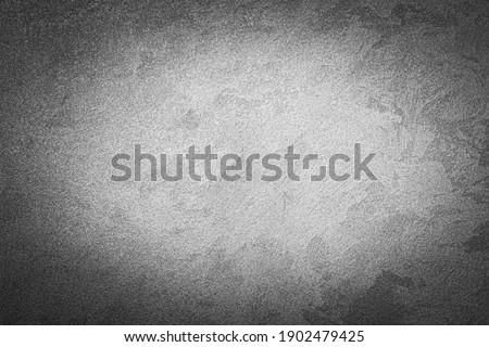 Gray decorative plaster texture with vignette. Abstract grunge background with copy space for design.