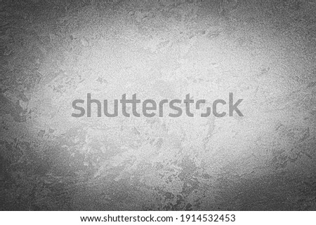 Gray decorative plaster texture with vignette. Abstract grunge background with copy space for design.