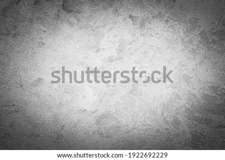 Gray decorative plaster texture with vignette. Abstract grunge background with copy space for design.