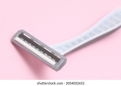 Gray Disposable Plastic Razor Blade Close Up On Pink Backround, Removing Unwanted Hair For Women