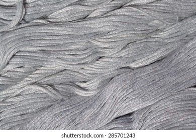 Gray embroidery floss as background texture close up 