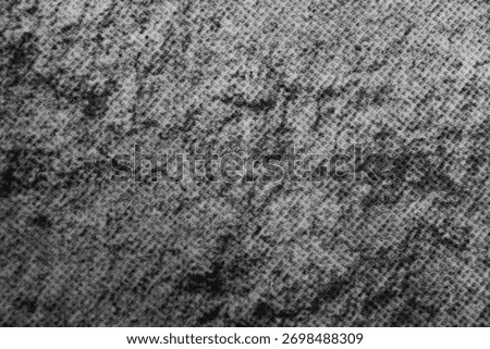 Gray fabric texture with dotted pattern and soft shadows, showing details of fibers and weave.