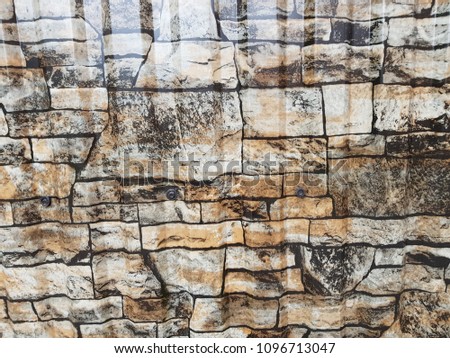 Gray facade facing tiles, imitating a stone. Background texture.