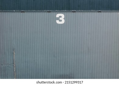 Gray Garage Door With The Number 3. Textured Background